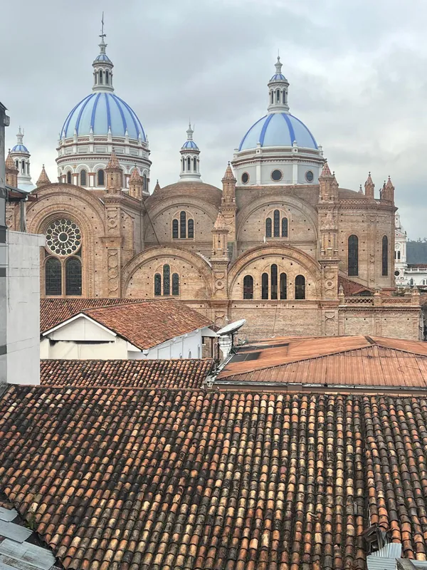 Morning yoga in a courtyard beneath the domes of Cuenca New Cathedral