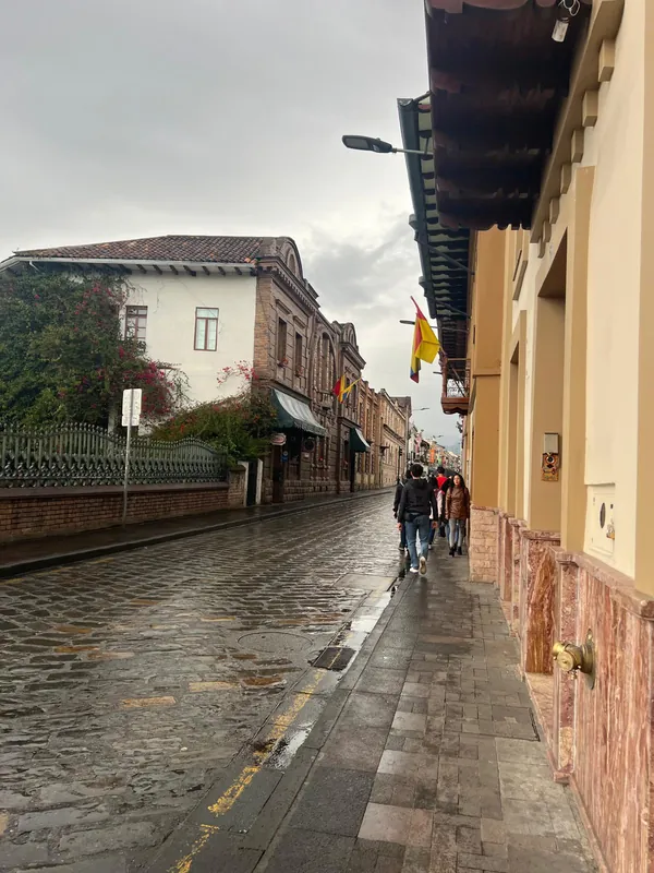 A rain-slicked cobblestone street in Cuenca historic Old Town